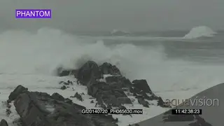 Big waves rolling in over rocks Overcast rain conditions PHANTOM