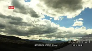 View of storm clouds moving over grass plain SCENIC TL