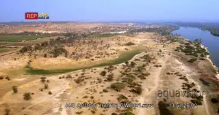 Aerial shot along chobe riverbank during dry season with kasane in the distance and.