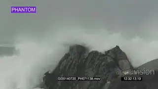 Big waves rolling in over rocks Overcast rain conditions PHANTOM