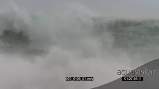 Big waves rolling in over rocks Overcast rain conditions