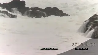 Big waves rolling in over rocks