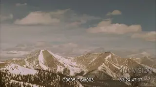 Rolling clouds over rugged mountains.
