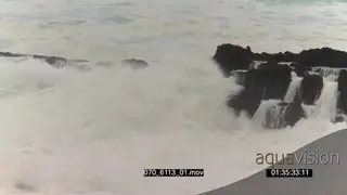 Big waves rolling in over rocks Overcast rain conditions