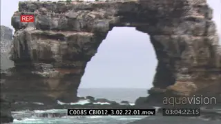 Scenic shot of galapagos island and rock with hole in it XLS;