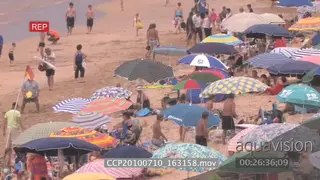 Scenic landscape shot beach people under umbrella's playing beach games general behaviour
