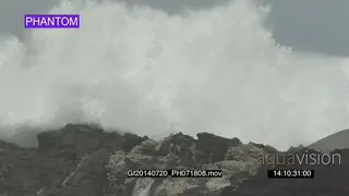 Big waves rolling in over rocks Overcast conditions
