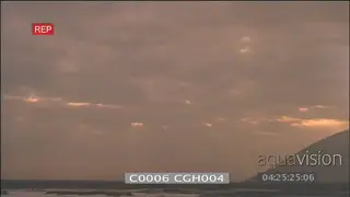 Timelapse of orange sunset rays clouds rolling over ocean