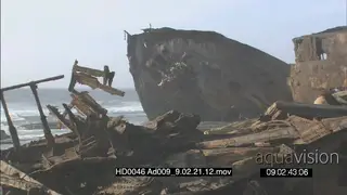 Shipwreck remains on beachfront rocks
