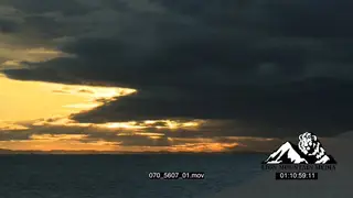 TL Sunrise over ocean ships travelling across Storm clouds