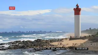 Durban beach people fishing general behaviour Lighthouse with Moses Mabhida stadium in.