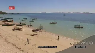 AERIAL of the Madagascar Island with two fishers walking around with fish nets around…