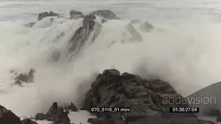 Big waves rolling in over rocks Overcast rain conditions