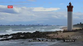 Durban beach people fishing general behaviour Lighthouse with Moses Mabhida stadium in.