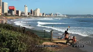 Scenic Durban beachfront People sitting on a beach general behaviour swimming surfing.