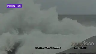 Big waves rolling in over rocks Overcast rain conditions PHANTOM