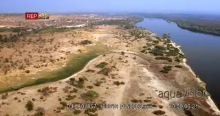 Aerial shot along chobe riverbank during dry season with kasane in the distance and.