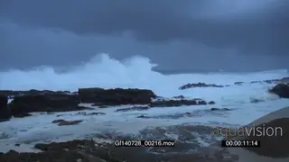 Big waves rolling in over rocks Overcast Storm clouds
