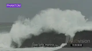 Big waves rolling in over rocks Overcast rain conditions PHANTOM