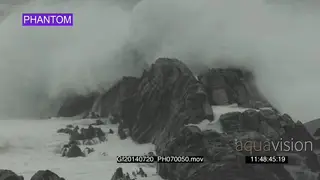 Big waves rolling in over rocks Overcast rain conditions PHANTOM