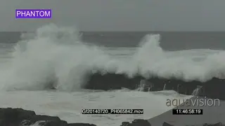 Big waves rolling in over rocks Overcast rain conditions PHANTOM