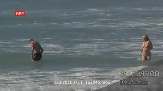 Man and woman playing jumping waves