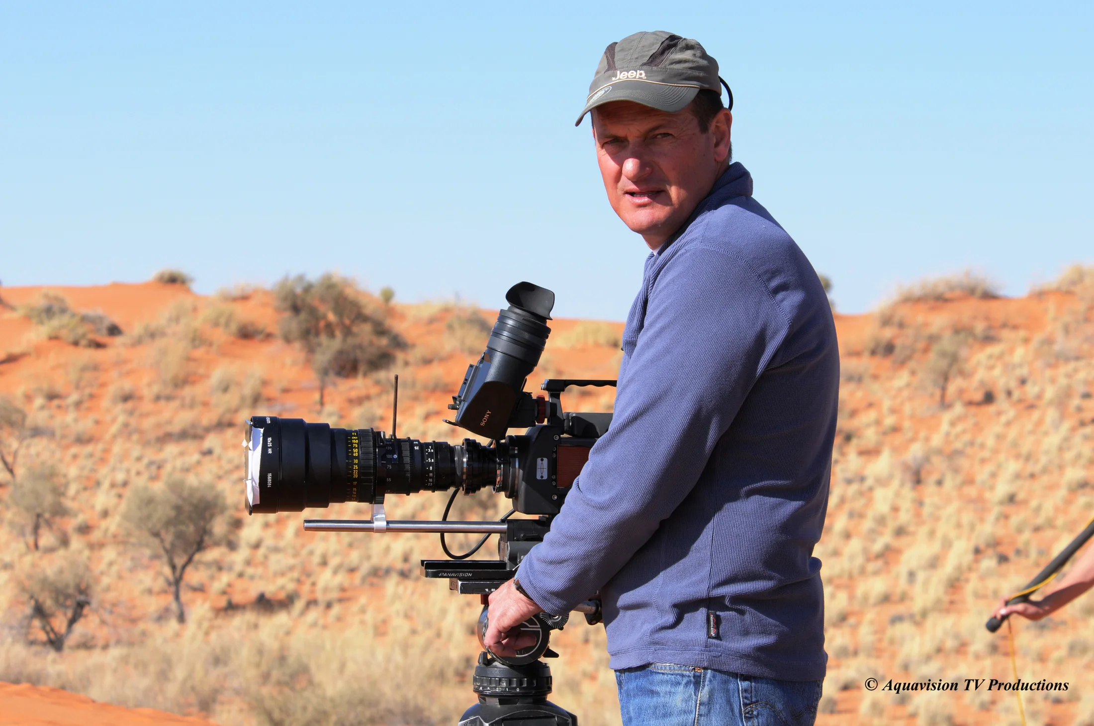 Camera operator with a cinema camera in the Kalahari